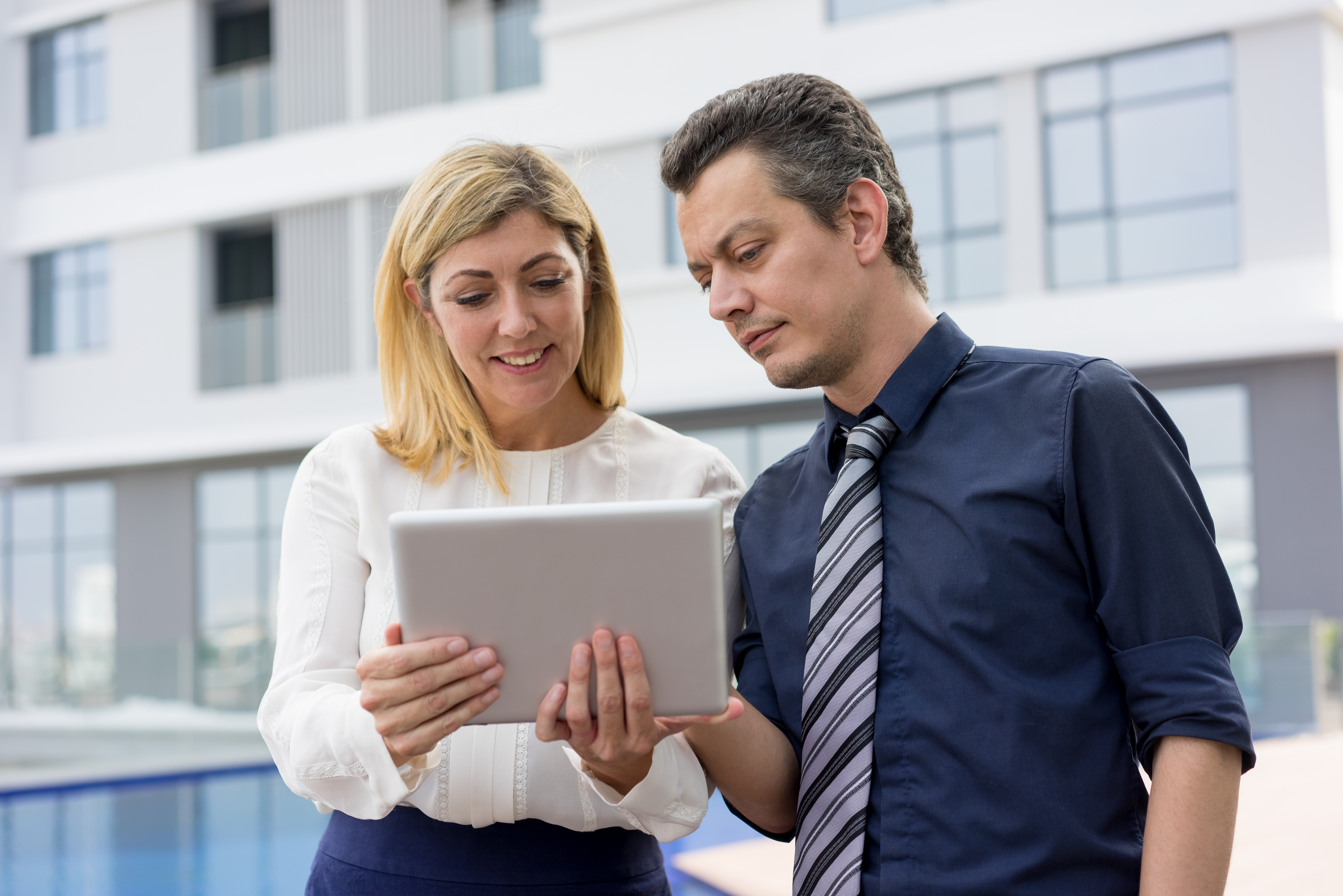 content business people reading news tablet computer outdoors